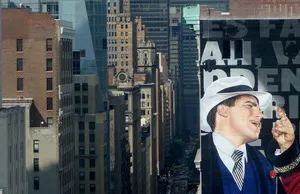 A large billboard looms over midtown Manhattan